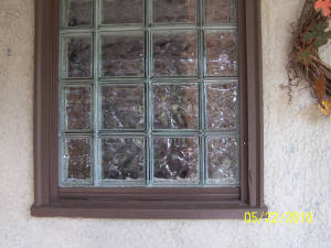 Glass block windows add security to your home.  This window is inside of a screened porch area in North Minneapolis.  If you look closely you can see where the burglar tried to pry the windo off and open.JPG